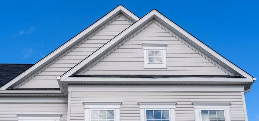Exterior view of a residence with HXHome Solutions' light grey siding, harmonizing with the blue sky backdrop for a timeless and modern aesthetic.