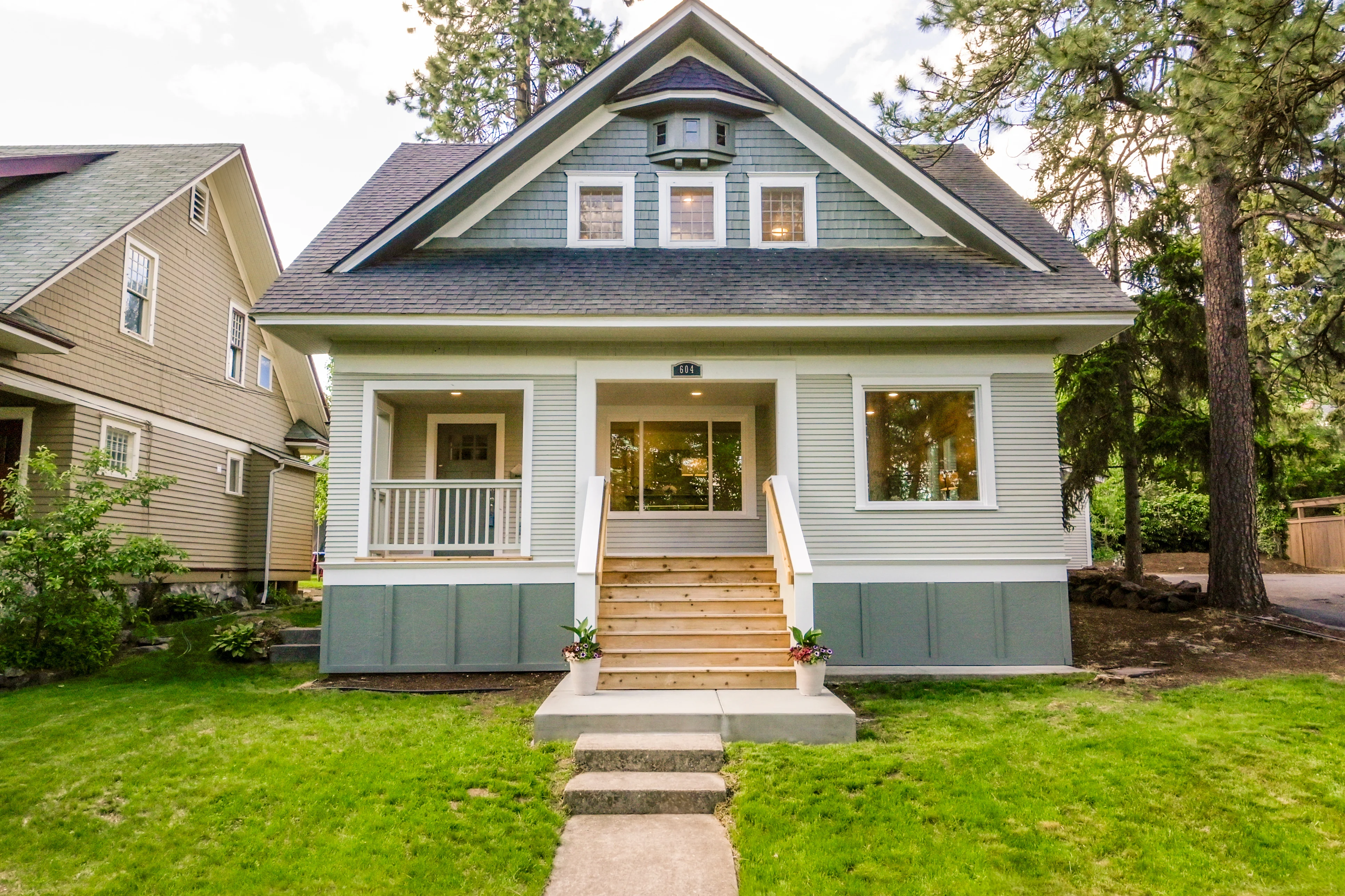 Craftsman-style home with gray-green siding, white trim, and new cedar front steps